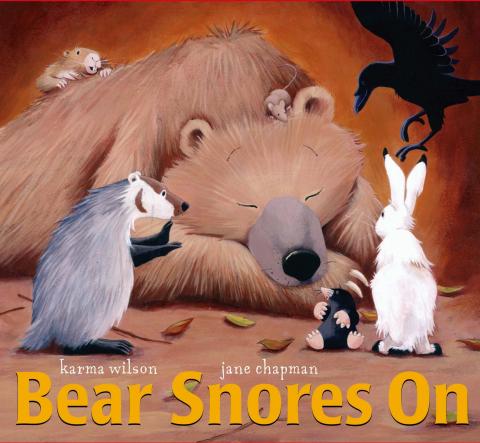 A bear asleep snoring with small animals standing in front