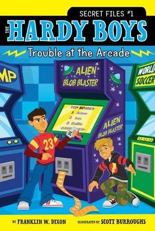 Two young boys next to an arcade game that is title alien blob blaster