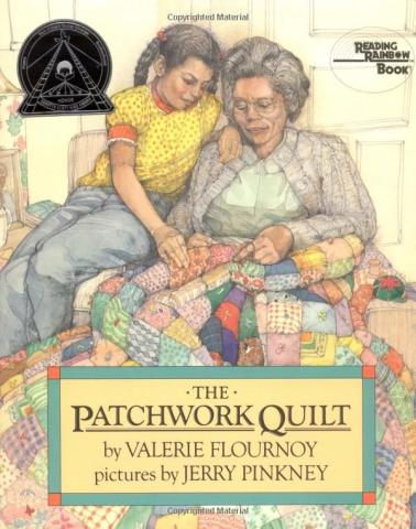 A young girl with two braids sitting on her grandmother's lap helping her to make a patchwork quilt