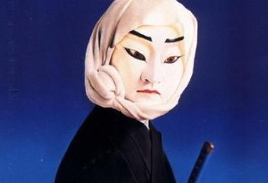 A puppet that is dressed as a samuri, or another classical Japan fighter