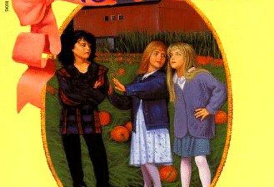 three young girls talking in a pumpkin patch