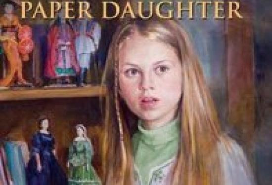 A young girl looking shocked in front of a book shelf of books and dolls