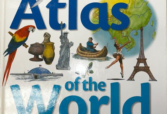 The cover of the book, big text reads "Atlas of the world", with different animals, insects, people, and monumnets placed around the cover