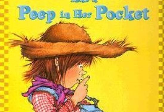 Junie B Jones is pulling her overalls away from her body and looking down at them with her finger to her lips in 'shhhh' fashion