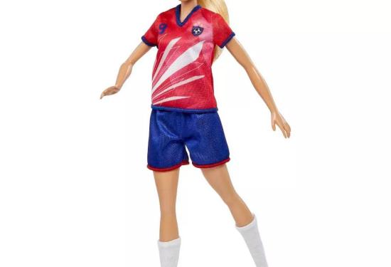 Soccer Player Barbie with her foot in motion to kick the soccer ball