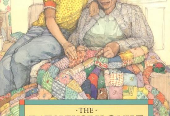 A young girl with two braids sitting on her grandmother's lap helping her to make a patchwork quilt